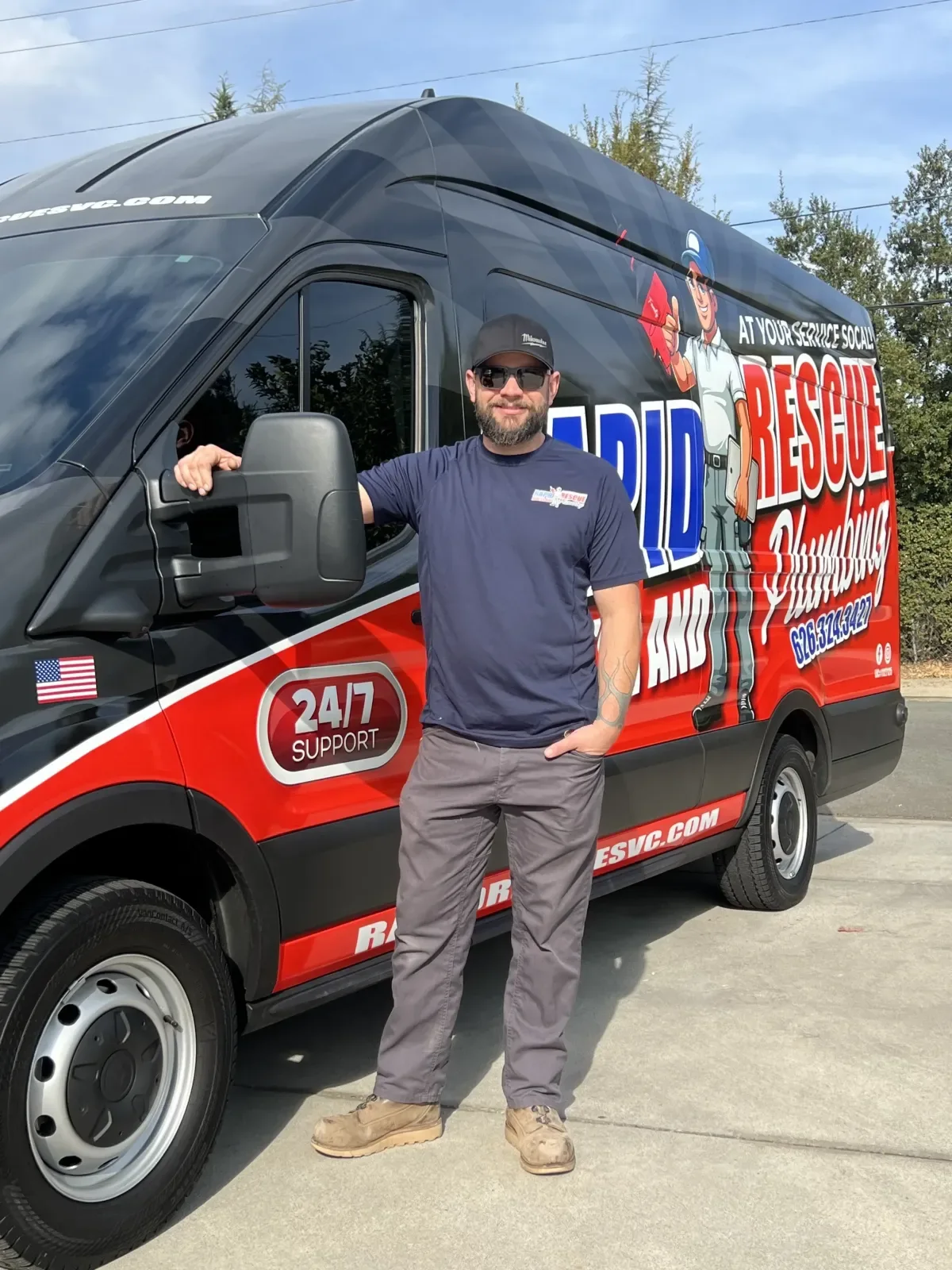 Plumber beside the Rapid Rescue service van