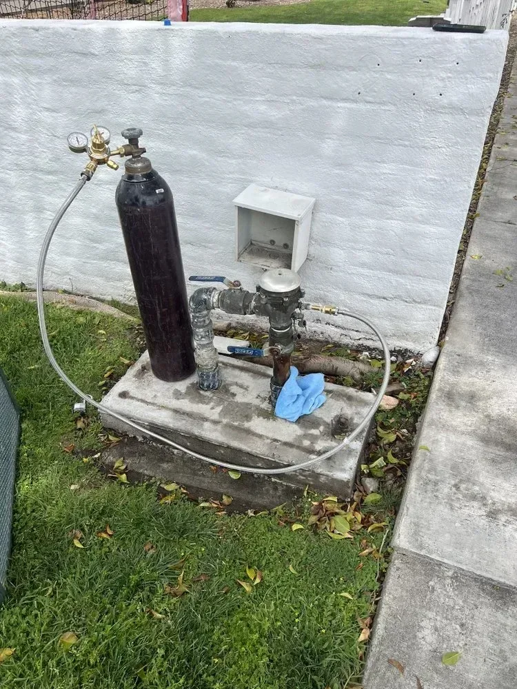 Leak-detection equipment positioned beside a concrete slab